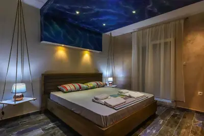 a bedroom with a bed with a painting on the ceiling at Apartments Amigo in Kotor