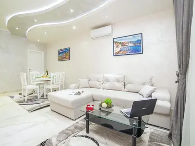 a living room with a white couch and a table at Apartments Amigo in Kotor