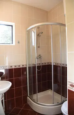a shower with a glass door in a bathroom at Apartments & Rooms Jelka in Kotor