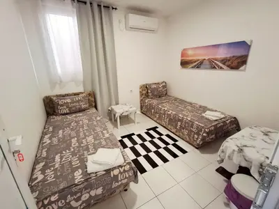 a living room with two beds and a couch at AS MONTENEGRO SUITES in Podgorica