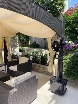 a patio with a fan and a table and chairs at Selena in Bar