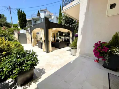 a patio with a gazebo and potted plants at Selena in Bar
