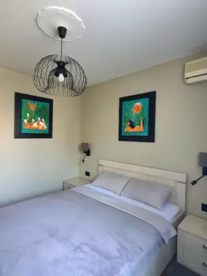 a bedroom with a bed and two pictures on the wall at Selena in Bar