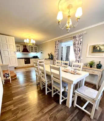 a kitchen and dining room with a white table and chairs at Selena in Bar