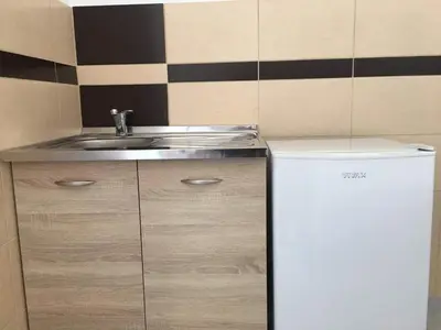 a small kitchen with a sink and a refrigerator at Apartments Flamida in Ulcinj