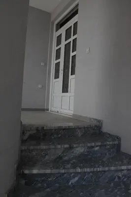 a door of a building with stairs leading to it at Apartments Flamida in Ulcinj
