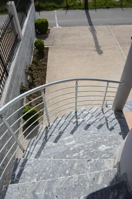 a metal railing on the stairs of a building at Apartments Flamida in Ulcinj