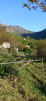 a view of a hill with a fence in a field at Etno House Mira in Virpazar