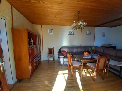 a living room with a table and a couch at Etno House Mira in Virpazar