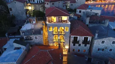 a building with lights on in a city at night at Apartments Timoni in Ulcinj