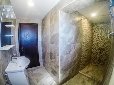 a bathroom with a shower and a toilet and a sink at Apartments Timoni in Ulcinj