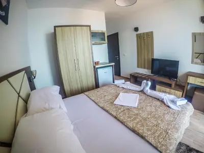 a hotel room with a bed and a television at Apartments Timoni in Ulcinj
