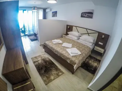 a bedroom with a bed with white sheets and pillows at Apartments Timoni in Ulcinj