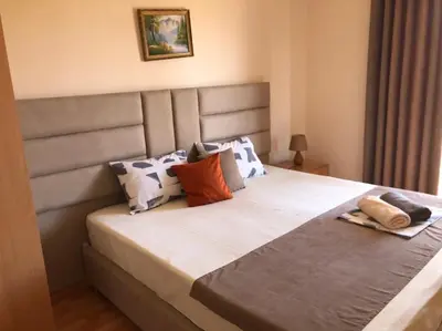 a bedroom with a large bed with pillows at Moonlight Apartments in Ulcinj