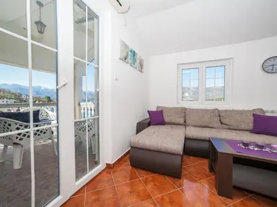 a living room with a couch and a table at Apartments Elena in Tivat
