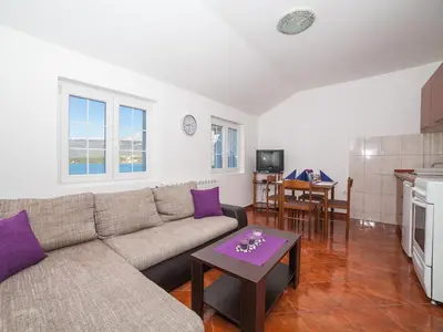 a living room with a couch and a table at Apartments Elena in Tivat