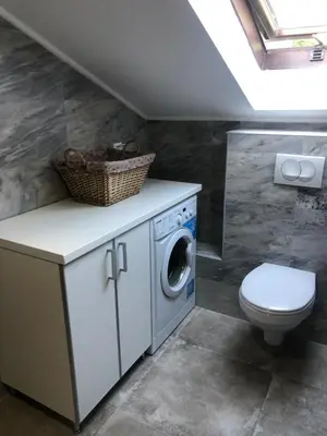 a bathroom with a washing machine and a toilet at Apartment Atina in Kotor