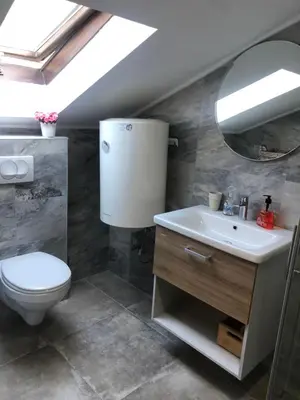 a bathroom with a toilet and a sink and a mirror at Apartment Atina in Kotor