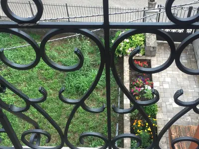 an iron gate with a garden behind it at Apartment Atina in Kotor