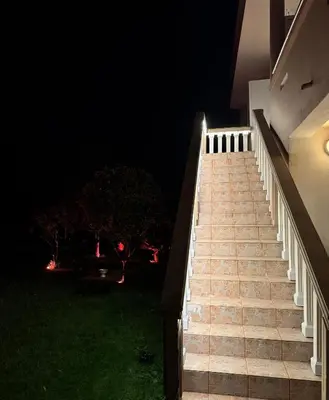a staircase leading up to a house at night at Studio Apartments Domenik in Ulcinj