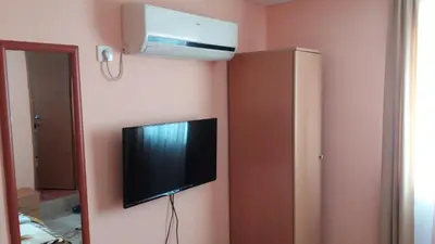 a flat screen tv hanging on a wall at Apartments Šofranac in Podgorica