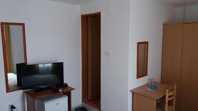 a room with a television and a small table with a mirror at Apartments Šofranac in Podgorica