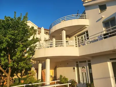a large white building with a balcony on it at Apartments Šofranac in Podgorica