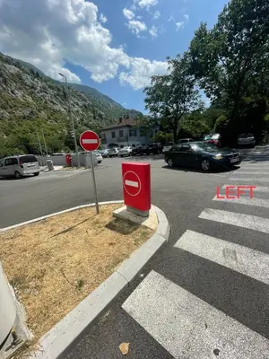 a red stop sign on the side of a street at Apartment Damjan in Kotor