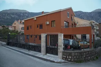 a house with a fence in front of it at Apartment Damjan in Kotor