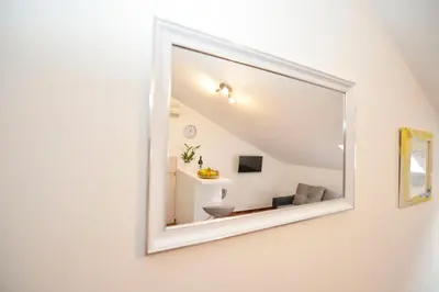 a mirror on the wall of a room at Apartment Damjan in Kotor