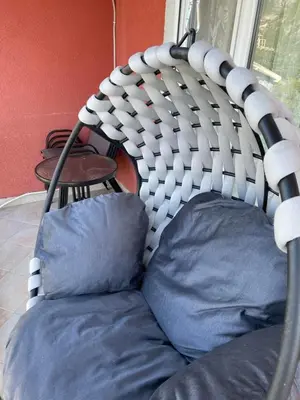 a chair with blue pillows sitting in a room at Apartments Neda in Sutomore