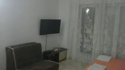 a living room with a chair and a television at Apartments Neda in Sutomore