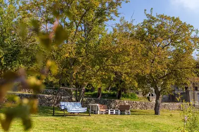 a park with a swing in the grass at Uphill Glavanovic Villas in Bar