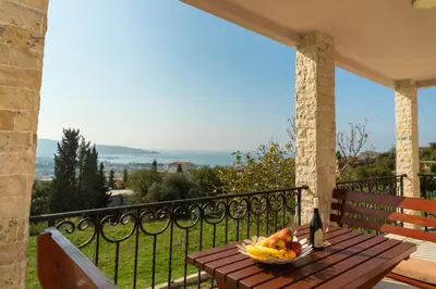 a bowl of fruit on a wooden table on a balcony at Uphill Glavanovic Villas in Bar