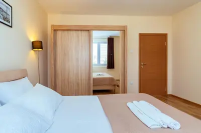 a bedroom with a bed with two towels on it at Uphill Glavanovic Villas in Bar