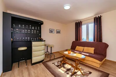 a living room with a couch and a table at Uphill Glavanovic Villas in Bar