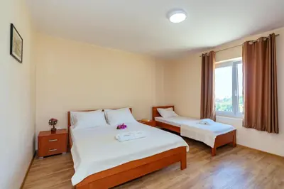a hotel room with two beds and a window at Uphill Glavanovic Villas in Bar