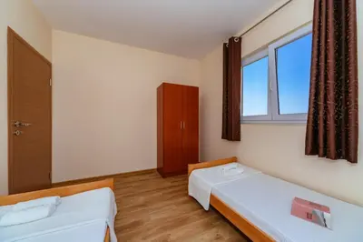 a room with two beds and a window at Uphill Glavanovic Villas in Bar