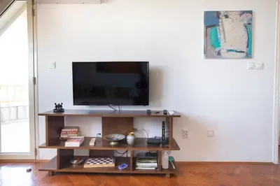 a living room with a flat screen tv on a shelf at Old town Beauty Apartment with great view in Podgorica