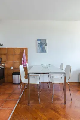a dining room with a table and white chairs at Old town Beauty Apartment with great view in Podgorica