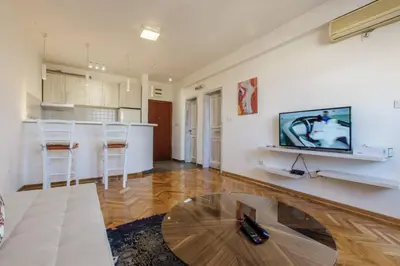 a living room with a table and a kitchen at Old town Beauty Apartment with great view in Podgorica