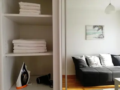 a living room with a couch and some towels at Apartment Olive Montenegro KO Becici in Budva