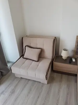a white couch in a room with a table at Avdiu Apartment in Ulcinj