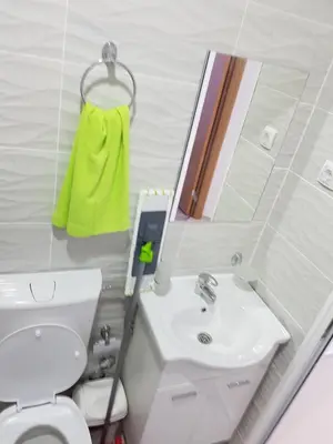 a bathroom with a toilet and a sink and a mirror at Avdiu Apartment in Ulcinj