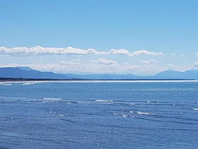 a large body of water with mountains in the background at Avdiu Apartment in Ulcinj