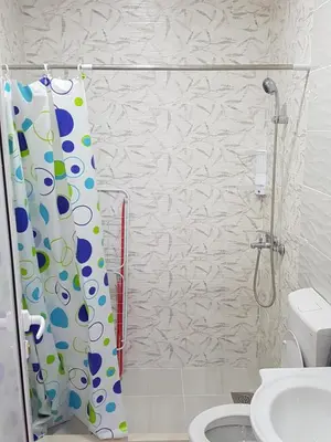 a bathroom with a shower curtain and a toilet at Avdiu Apartment in Ulcinj