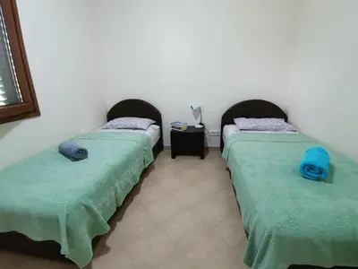 two beds sitting next to each other in a room at Guest House Radulovic in Petrovac na Moru