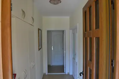 a hallway with a door leading into a room at Guest House Radulovic in Petrovac na Moru