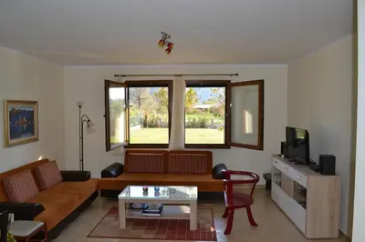 a living room with a couch and a tv at Guest House Radulovic in Petrovac na Moru