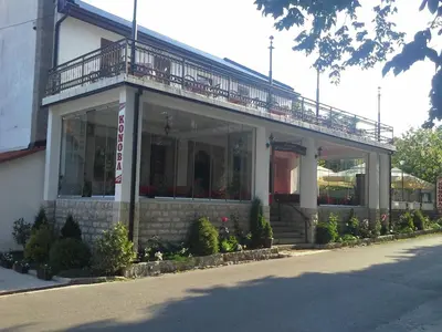 a building with a balcony on top of it at BNB Njeguska sijela in Njeguši